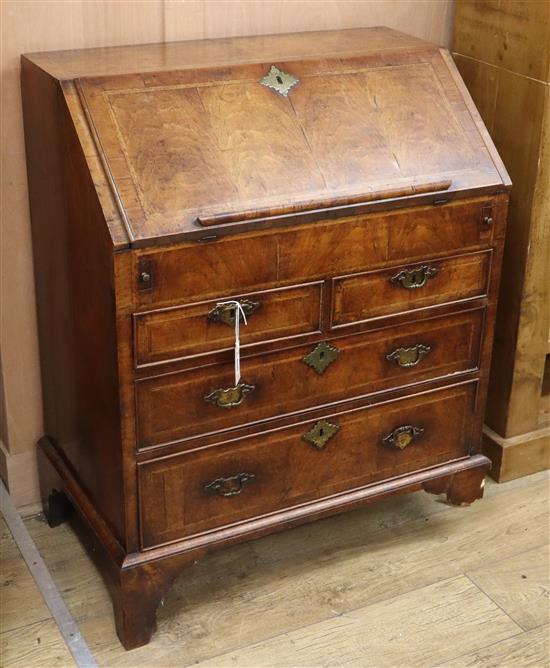 An early 18th century herringbone crossbanded walnut bureau (a.f.) W.76cm